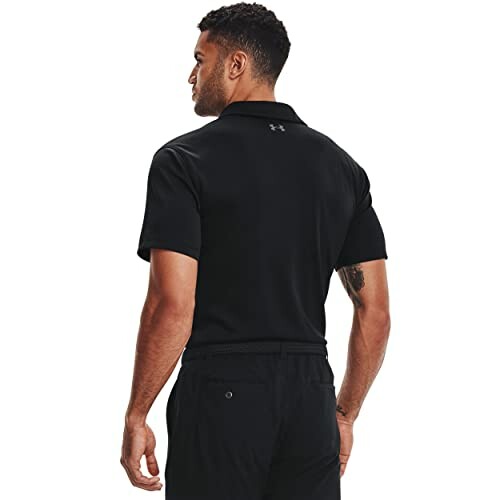 Man wearing a black polo shirt viewed from the back.