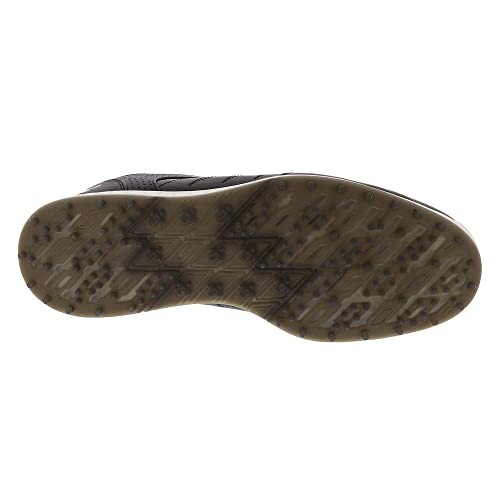 Bottom view of a golf shoe with grip studs.